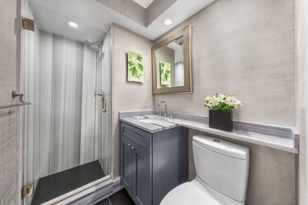 a bathroom with a sink toilet and shower