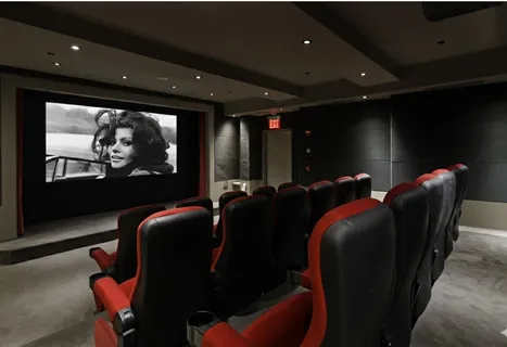 a media room with lots of chairs and a projector screen