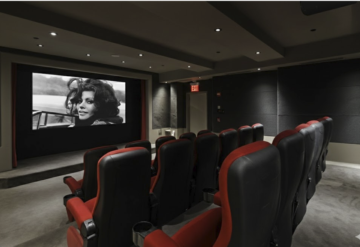 15 Broad Street, Unit 2300 Manhattan, NY 10005 - Photo 26 of 36 a media room with lots of chairs and a projector screen