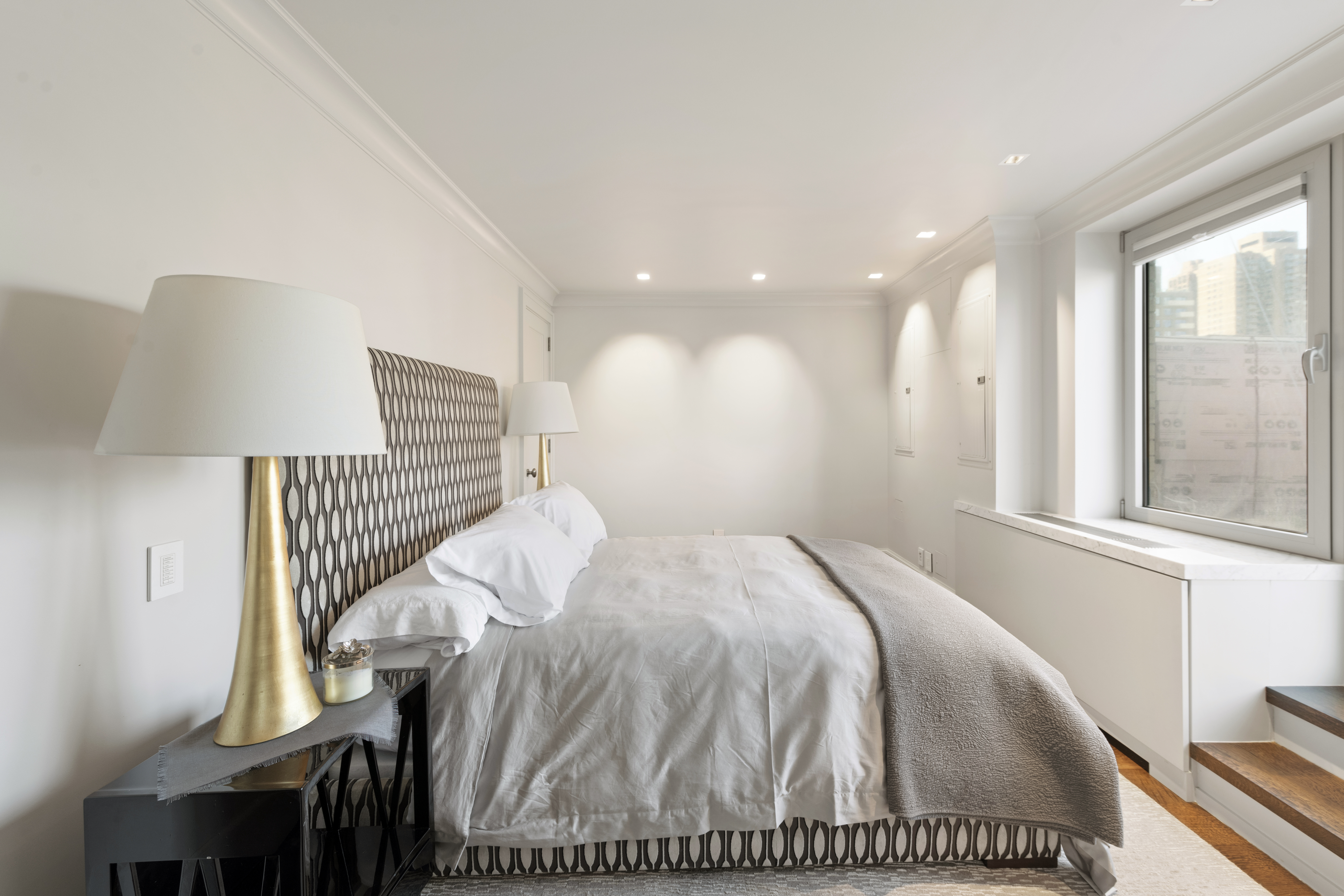 180 East End Avenue, Unit 15E Manhattan, NY 10128 - Photo 16 of 31 a bed sitting in a bedroom next to a window