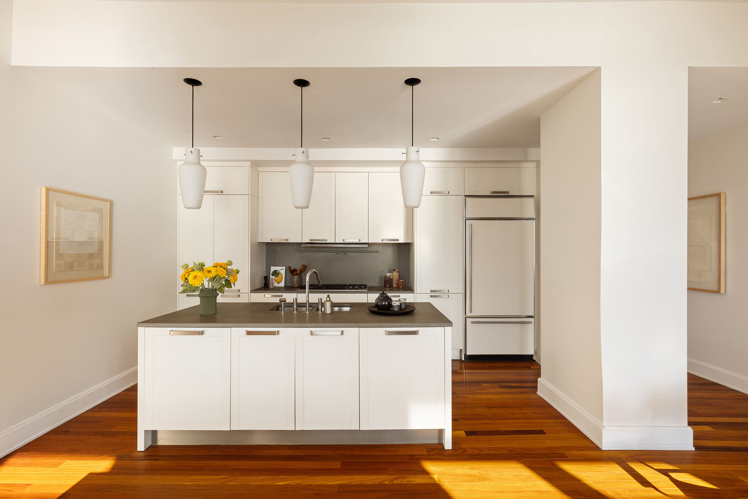 92 Laight Street, Unit 6D Manhattan, NY 10013 - Photo 5 of 15 a kitchen with stainless steel appliances granite countertop a stove a sink and white cabinets