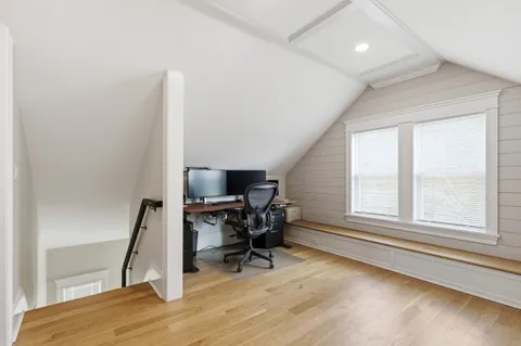 a view of a workspace with furniture and a window