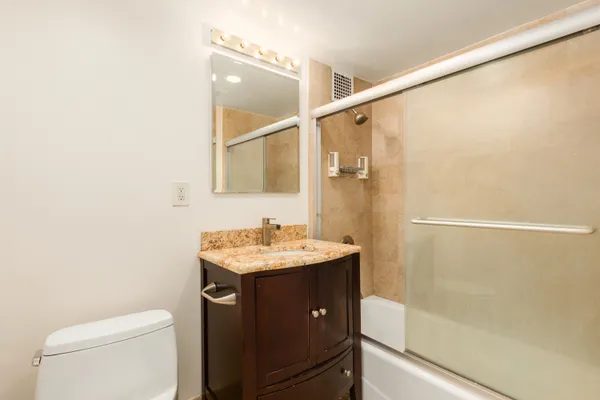 a bathroom with a toilet a sink and shower