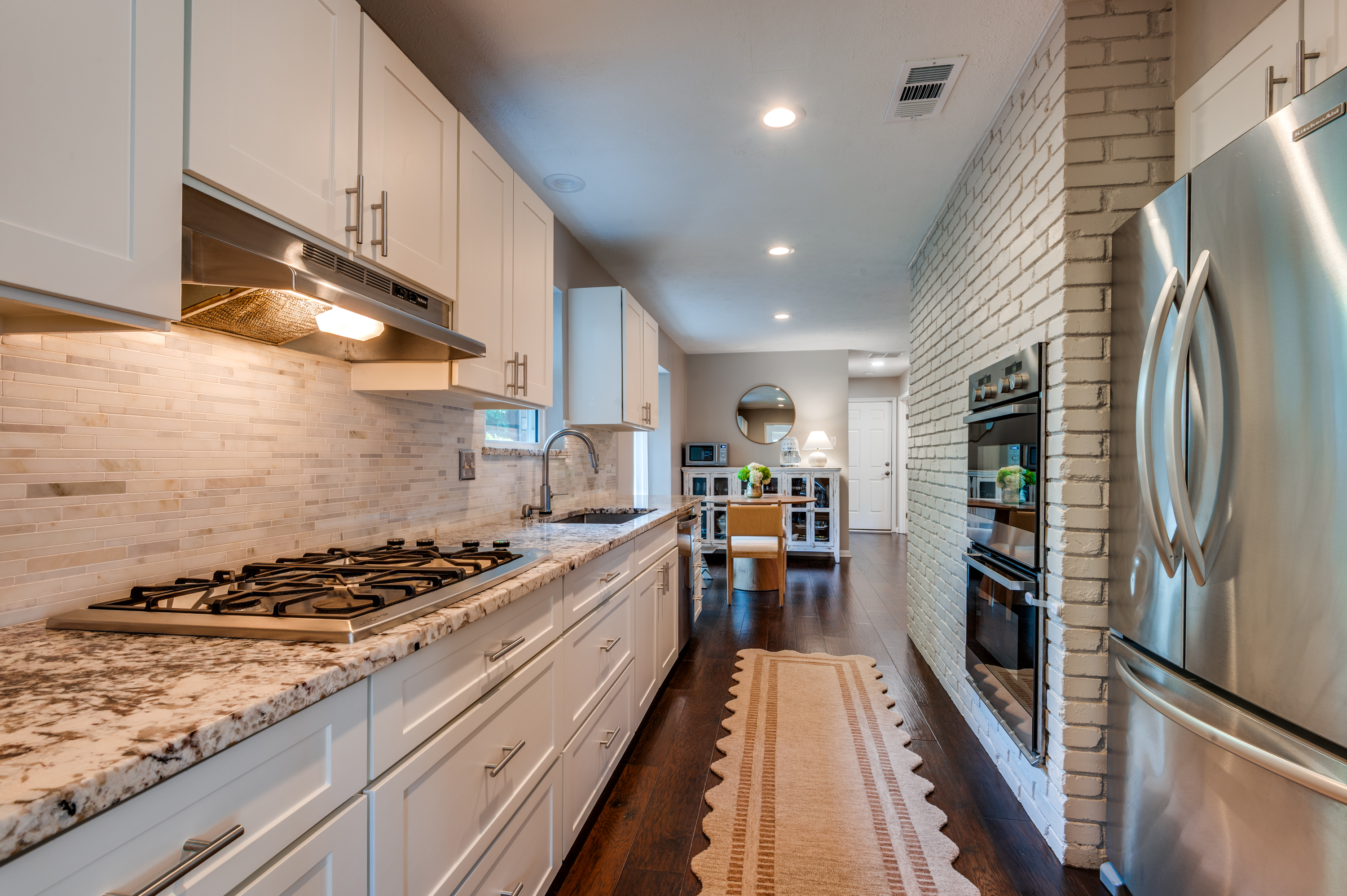 3363 Merrell Road Dallas, TX 75229 - Photo 13 of 29 a kitchen with stainless steel appliances granite countertop a refrigerator a stove and a sink