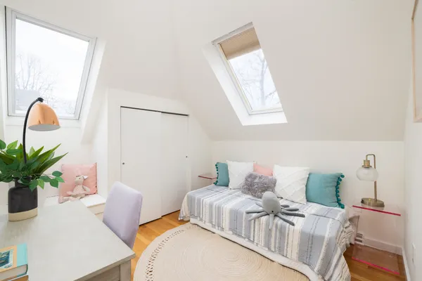 a bedroom with a bed and a potted plant
