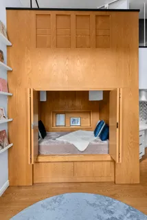 a living room with a couch and floor to ceiling window