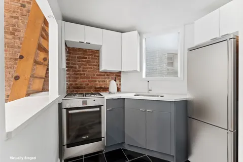 a kitchen with a stove sink and cabinets