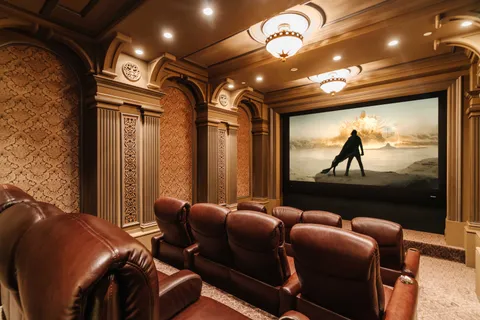 a media room with lots of chairs and a projector screen