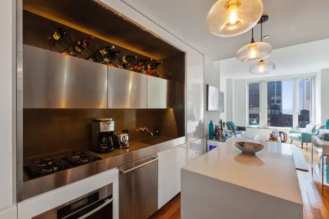a kitchen with a sink stainless steel appliances and cabinets