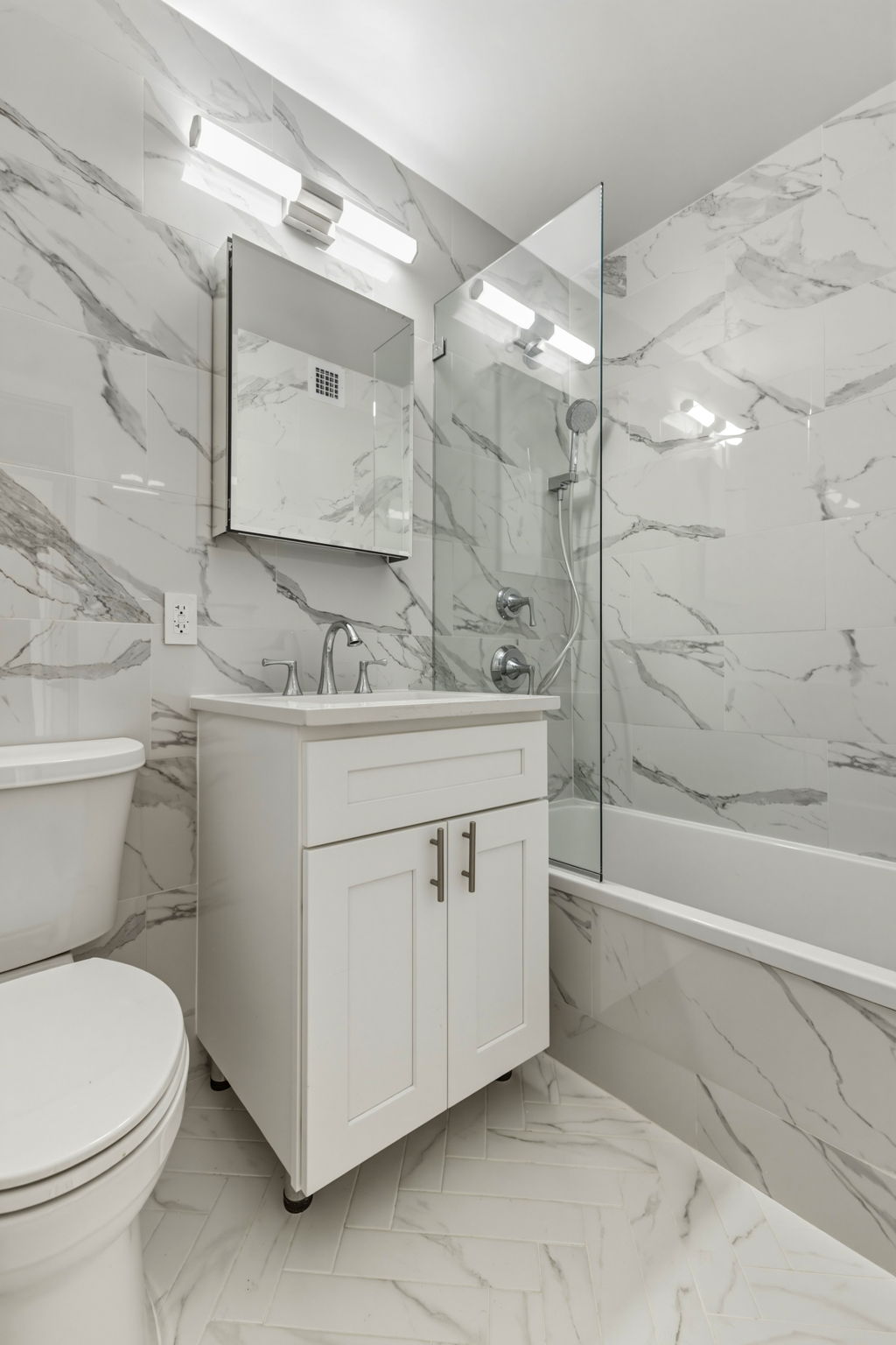 400 East 54th Street, Unit 24E Manhattan, NY 10022 - Photo 16 of 29 a bathroom with a sink toilet vanity and shower