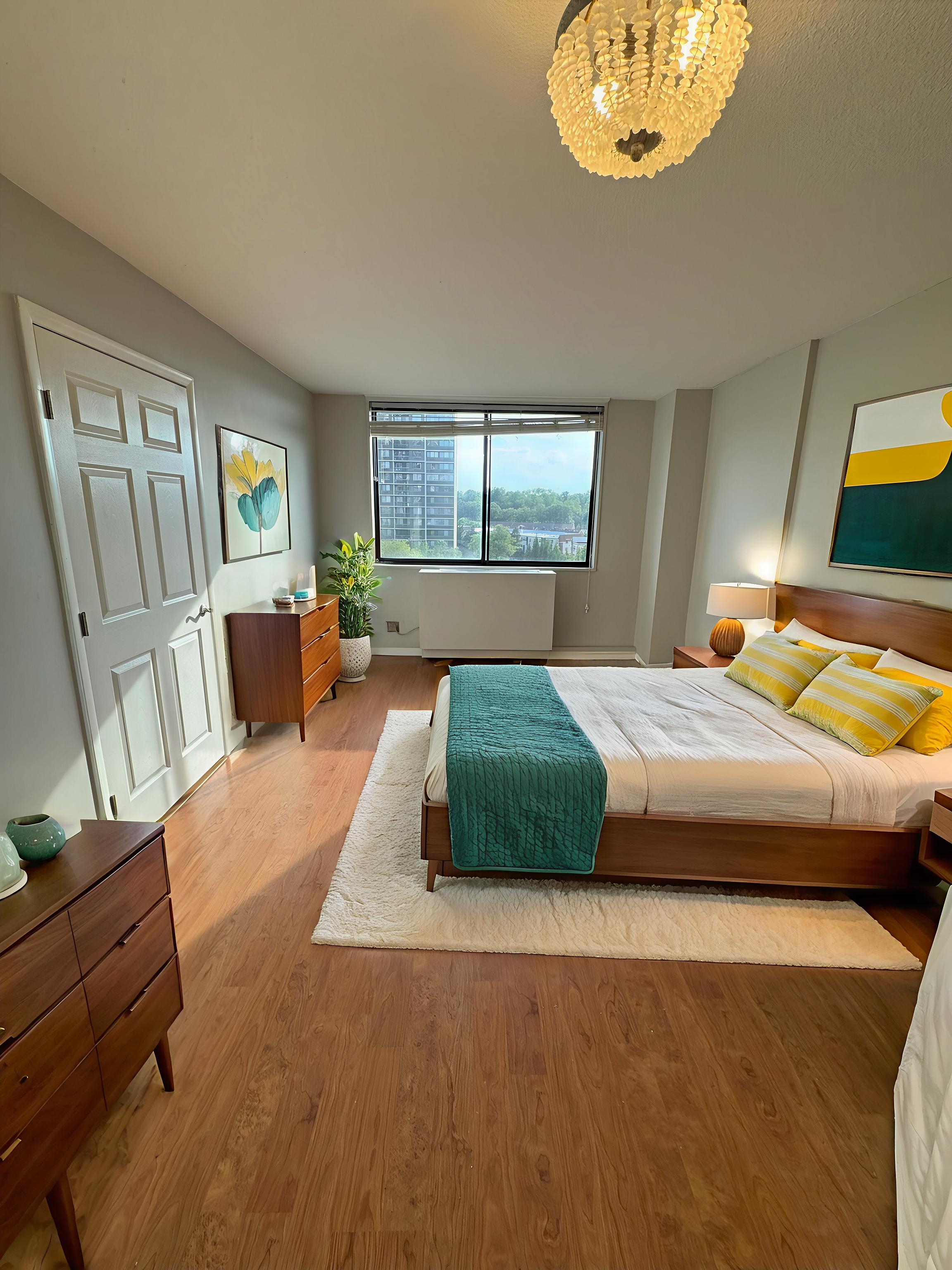 2 Bay Club Drive, Unit 8V Queens, NY 11360 - Photo 2 of 17 a bedroom with a large bed and a chandelier