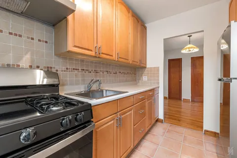 a kitchen with stainless steel appliances granite countertop a stove and a sink