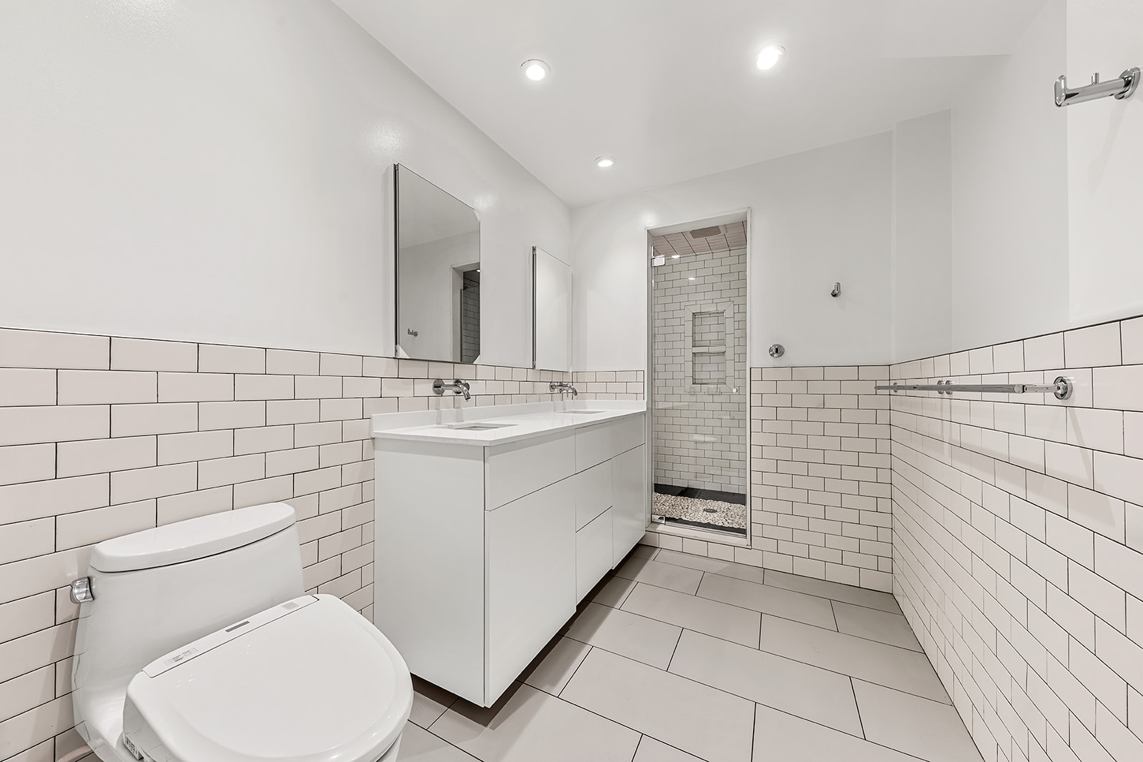130 Watts Street, Unit 5N Manhattan, NY 10013 - Photo 5 of 11 a bathroom with a sink a toilet and mirror