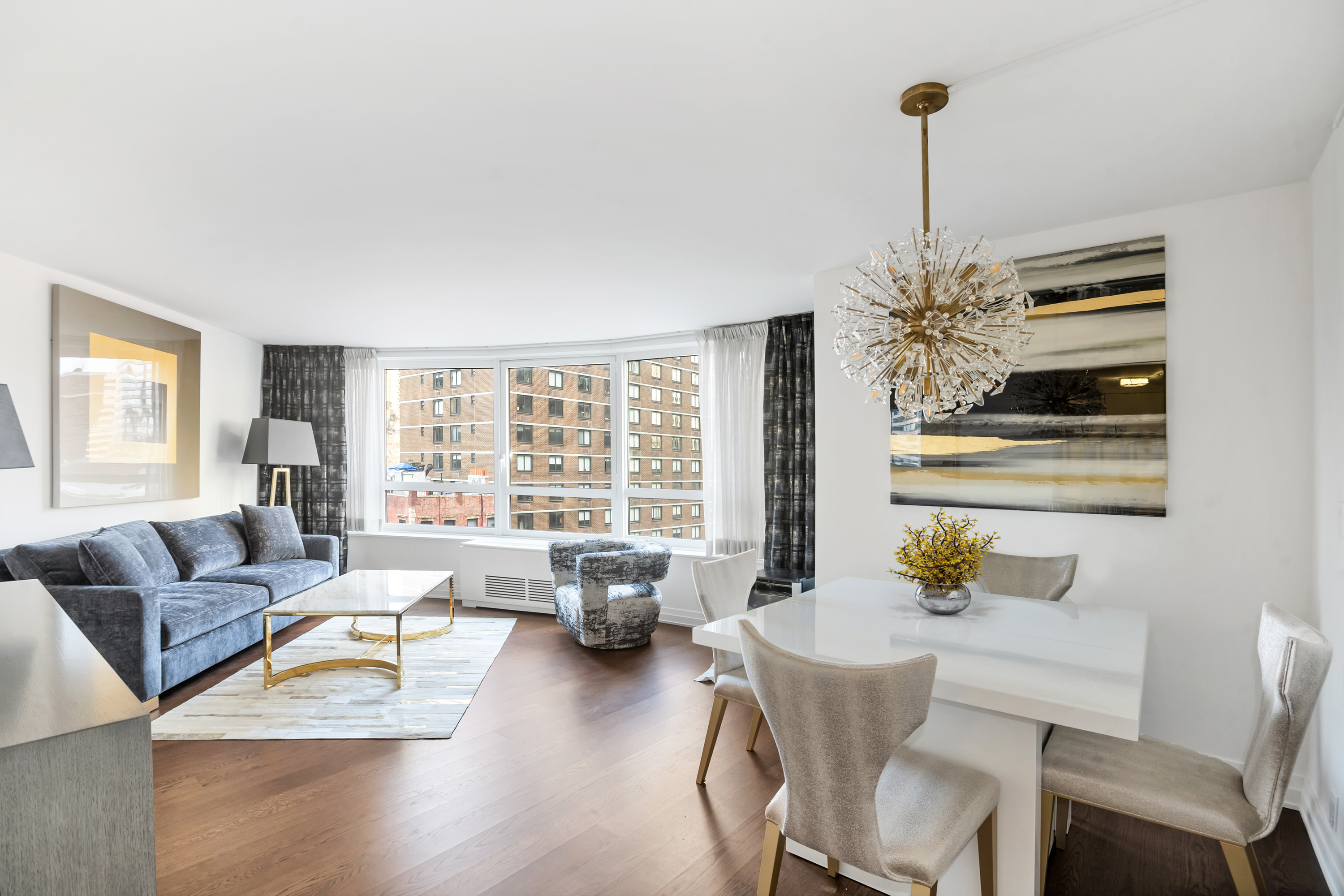 200 East 94th Street, Unit 615 Manhattan, NY 10128 - Photo 1 of 11 a living room with furniture and a wooden floor