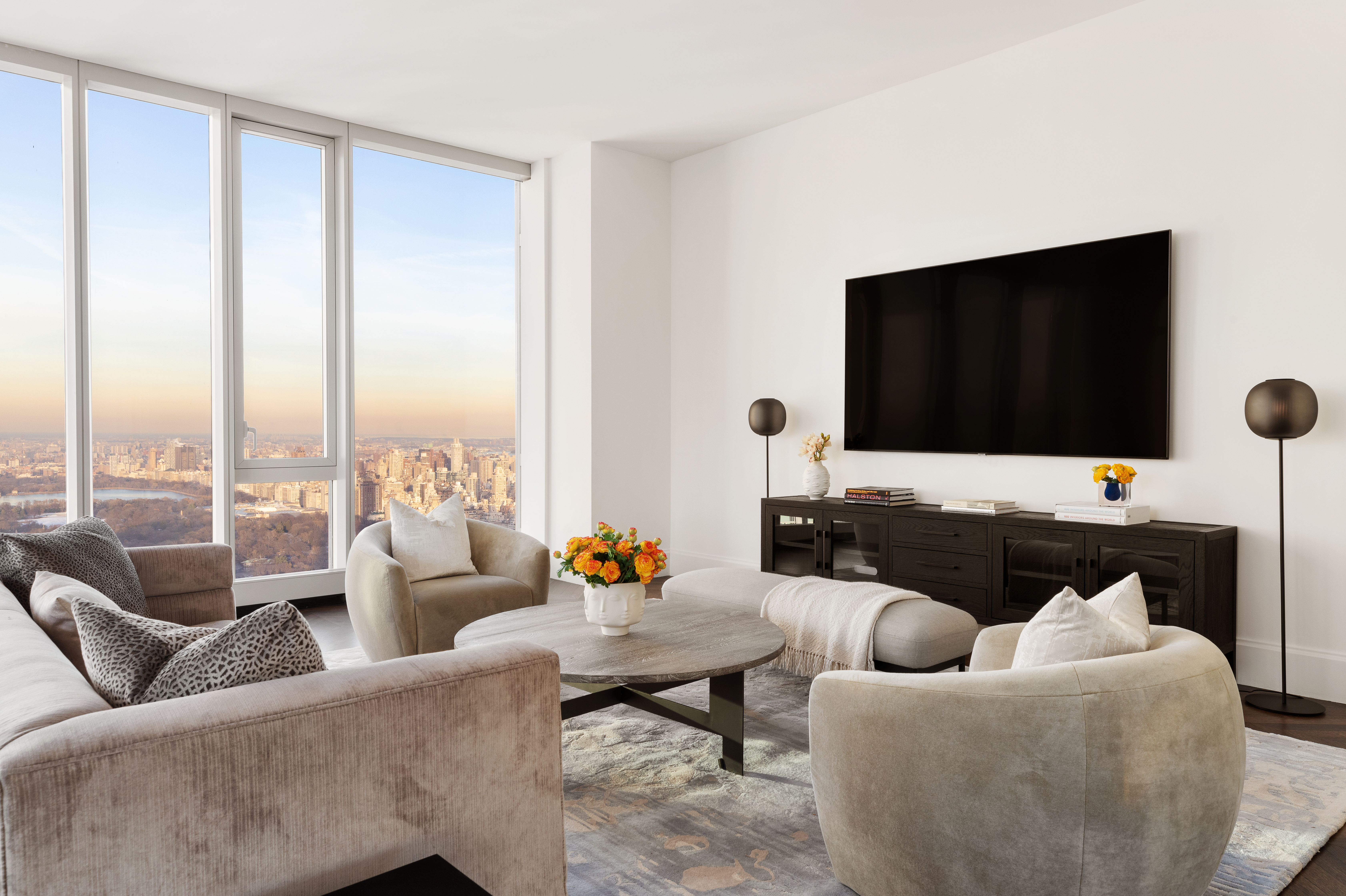 217 West 57th Street, Unit 60W Manhattan, NY 10019 - Photo 2 of 27 a living room with furniture and a flat screen tv