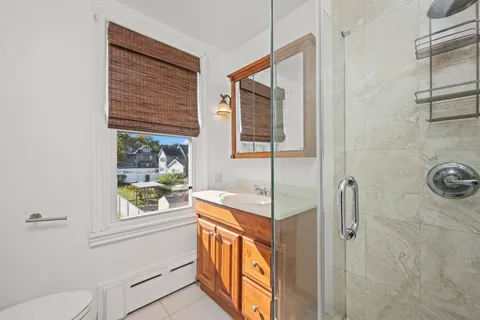 a view of a livingroom with wooden floor and a ceiling fan