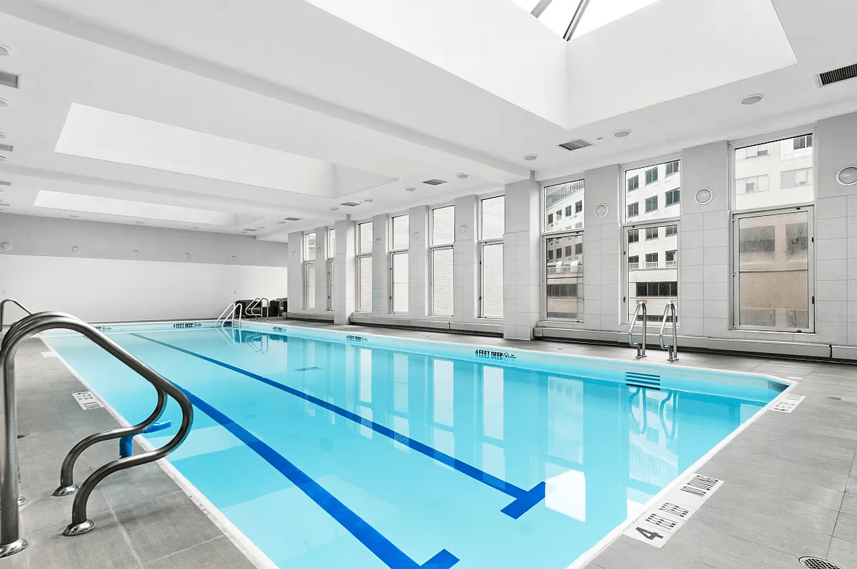 524 East 72nd Street, Unit 26A Manhattan, NY 10021 - Photo 11 of 16 a kitchen with stainless steel appliances granite countertop a sink and a cabinets