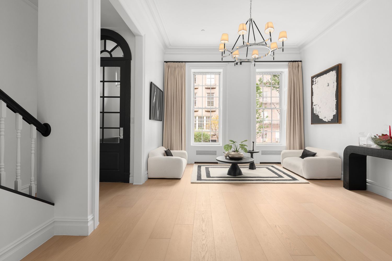 222 East 61st Street Manhattan, NY 10065 - Photo 5 of 28 a living room with furniture and large windows