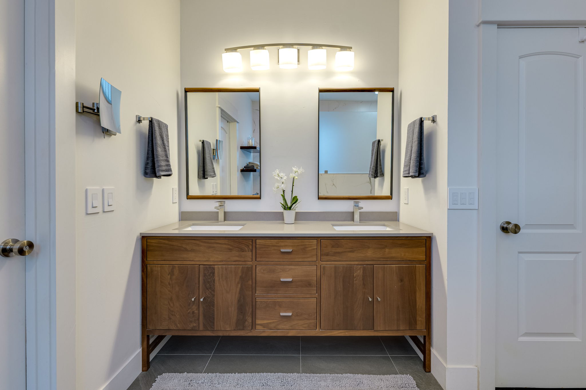 109 West Spring Drive Austin, TX 78746 - Photo 16 of 22 a bathroom with a double vanity sink and a mirror