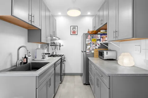 a kitchen with stainless steel appliances granite countertop a sink and a stove