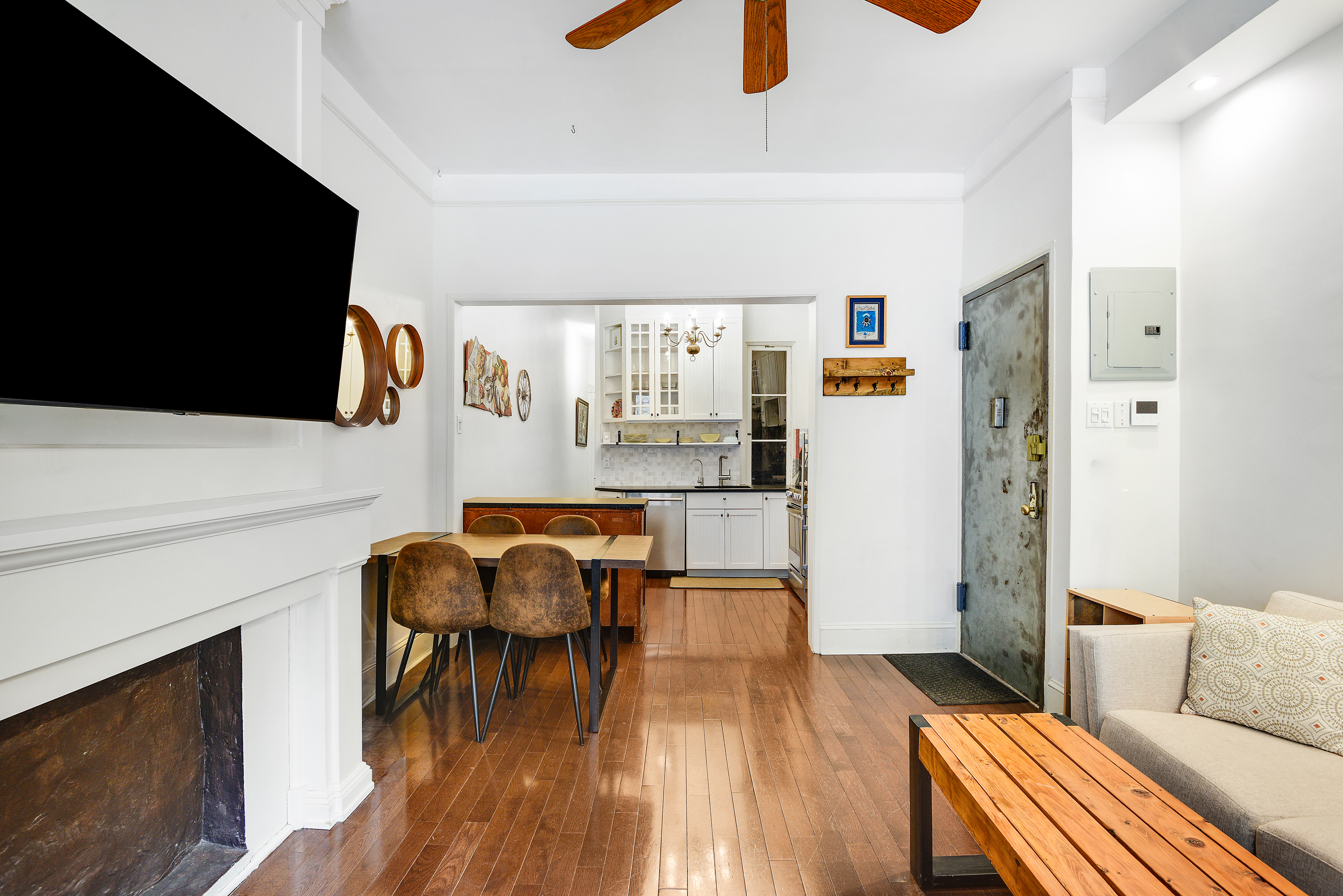 436 East 66th Street, Unit 1W Manhattan, NY 10065 - Photo 6 of 19 a living room with furniture and a flat screen tv