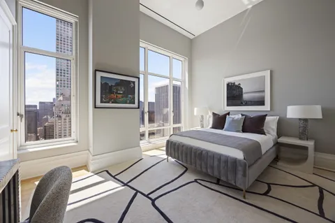 a bedroom with a bed and windows