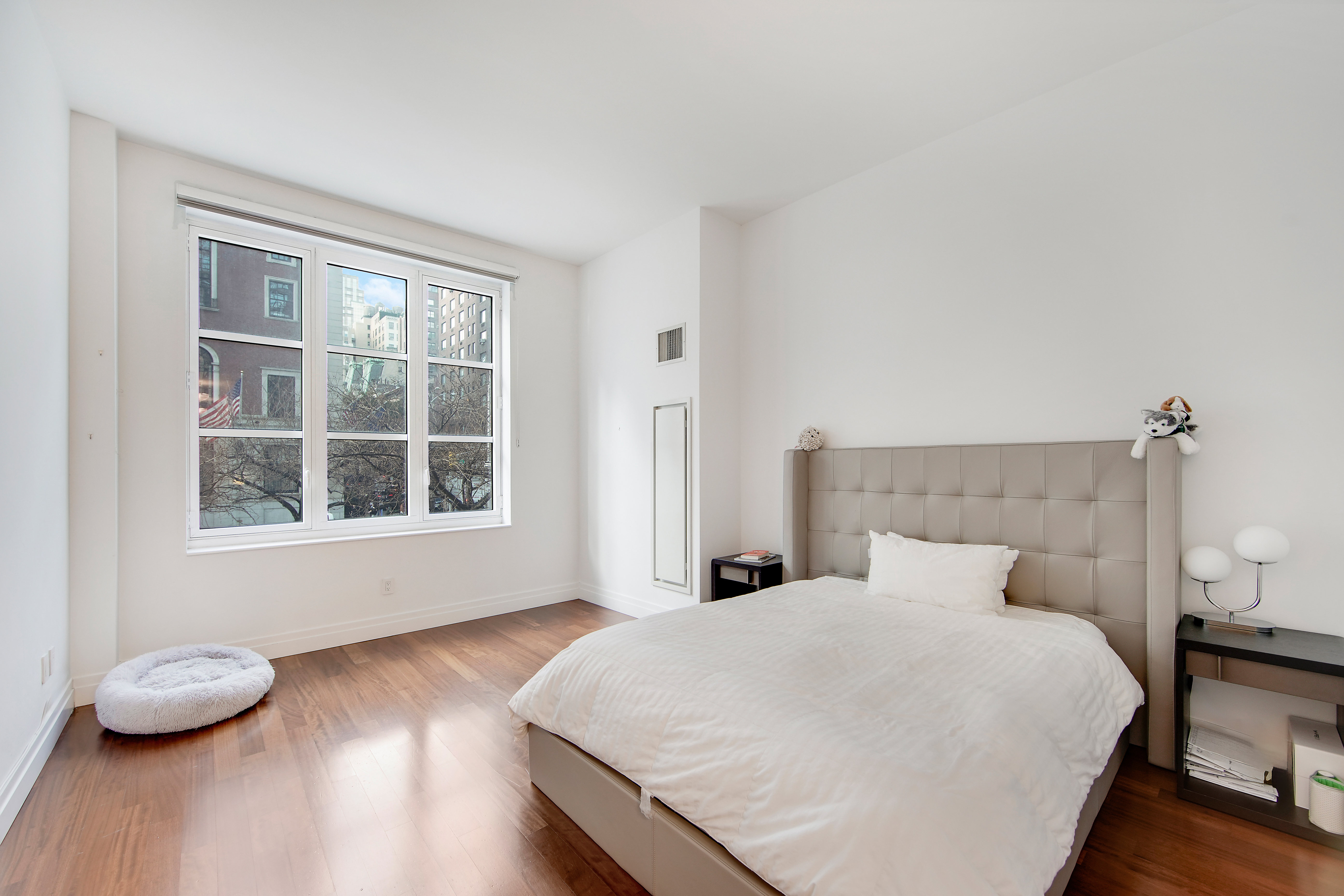 45 Park Avenue, Unit 202 Manhattan, NY 10016 - Photo 6 of 17 a bedroom with a bed and wooden floor
