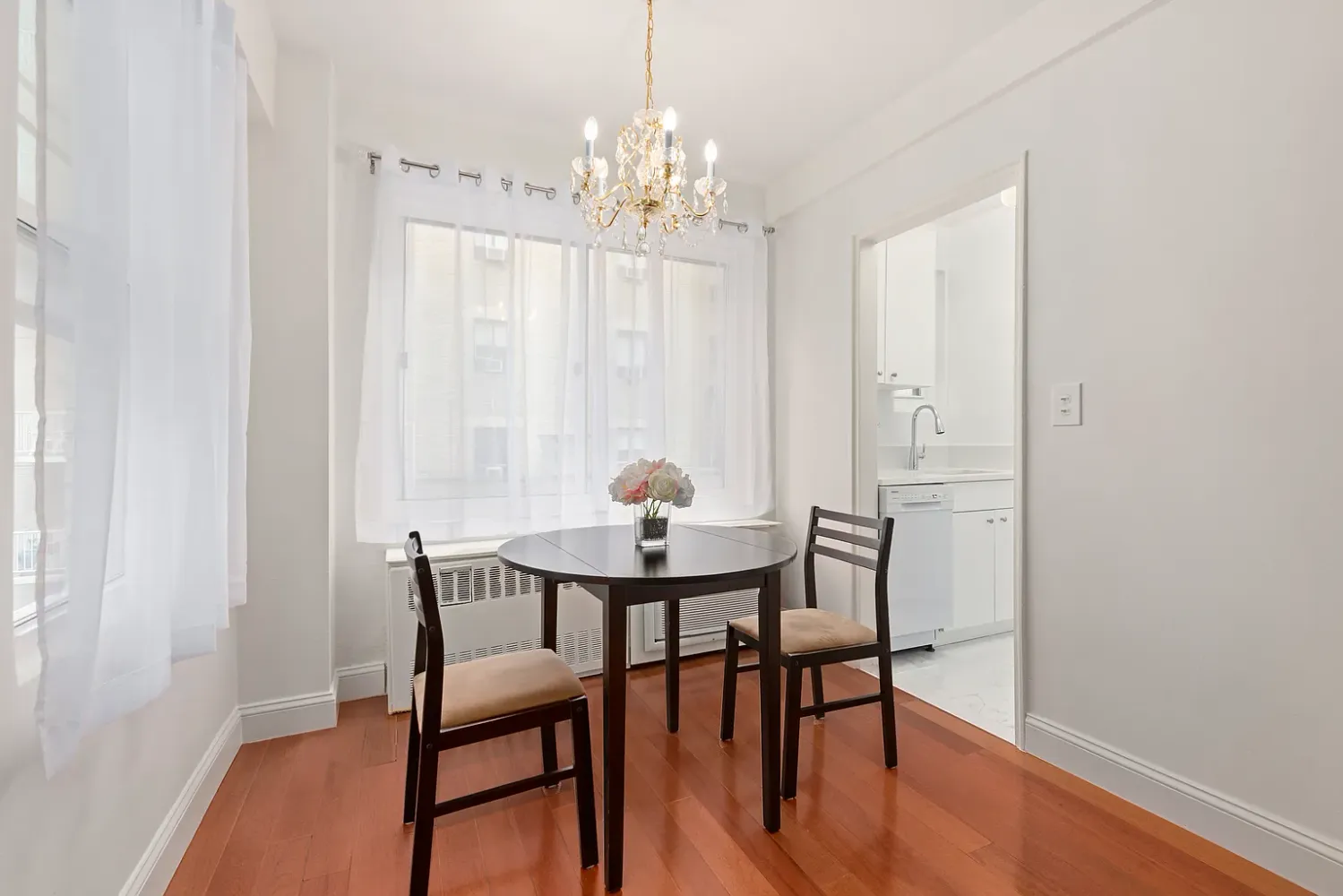 a view of a dining room with furniture and chandelier