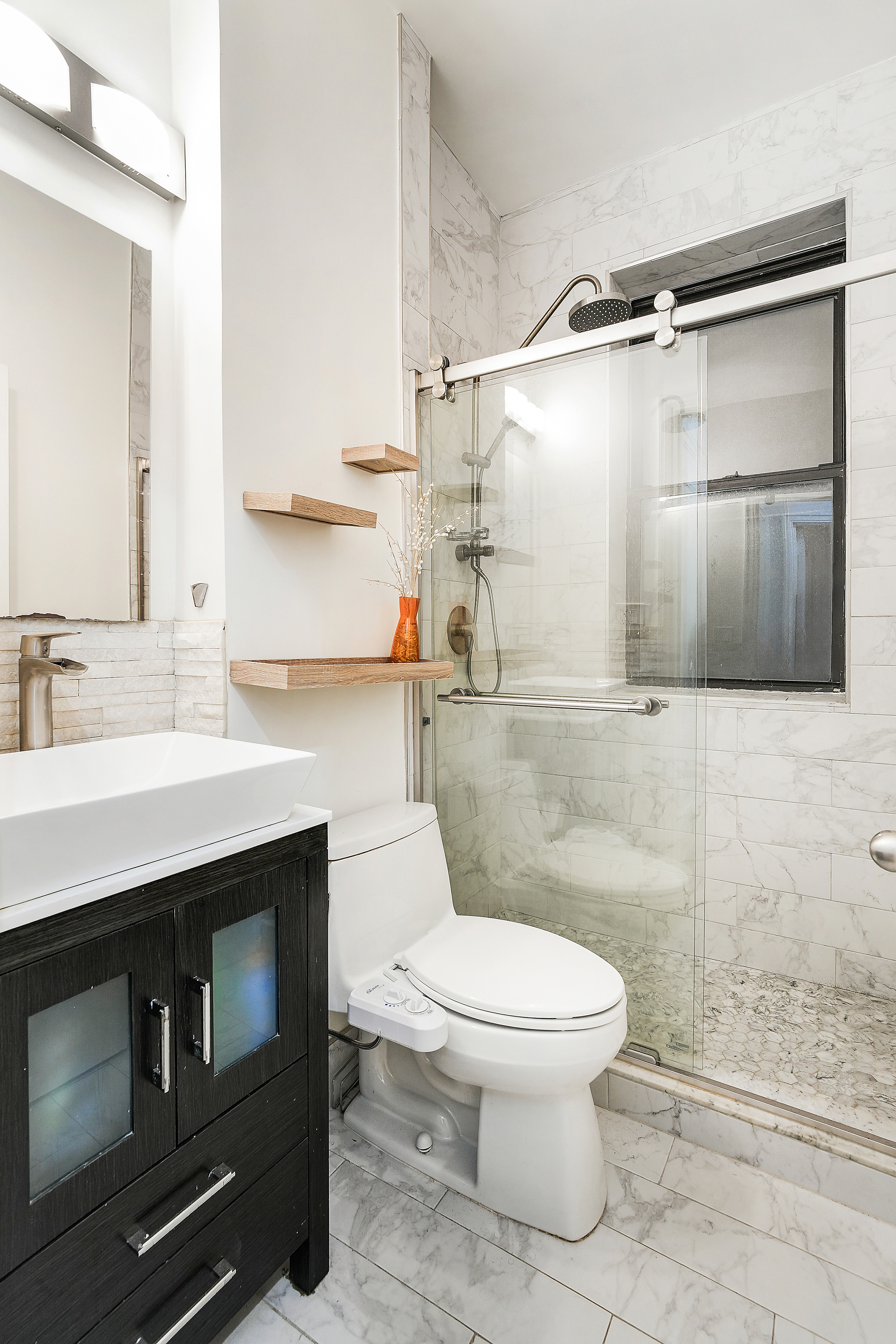 205 West 54th Street, Unit 3A Manhattan, NY 10019 - Photo 9 of 14 a bathroom with a sink a toilet and shower