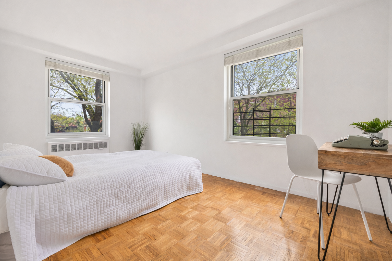 35-51 85th Street, Unit 4K Queens, NY 11372 - Photo 9 of 11 a bedroom with a bed and a chair
