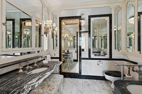 a bathroom with a tub a double vanity sink and mirror
