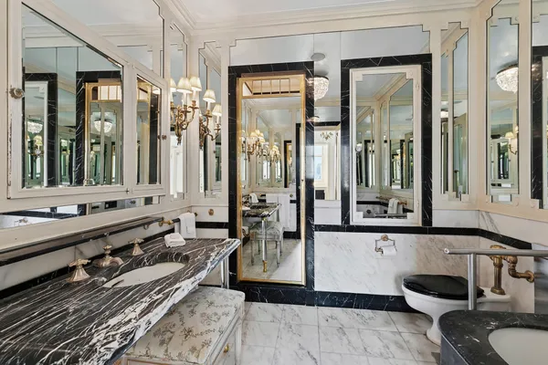 a bathroom with a tub a double vanity sink and mirror