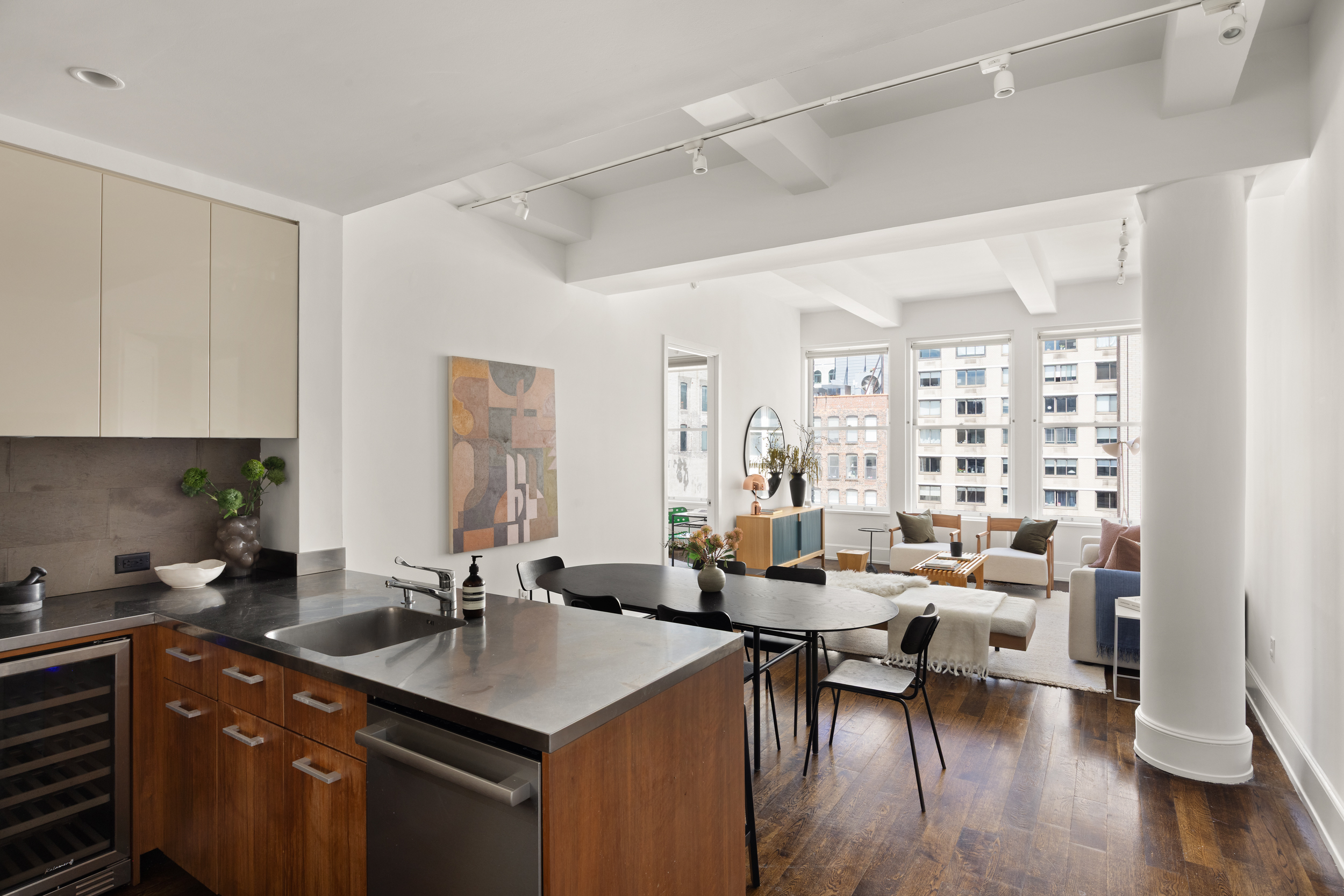 260 Park Avenue South, Unit 9G Manhattan, NY 10010 - Photo 3 of 17 a kitchen with a table chairs and a couch