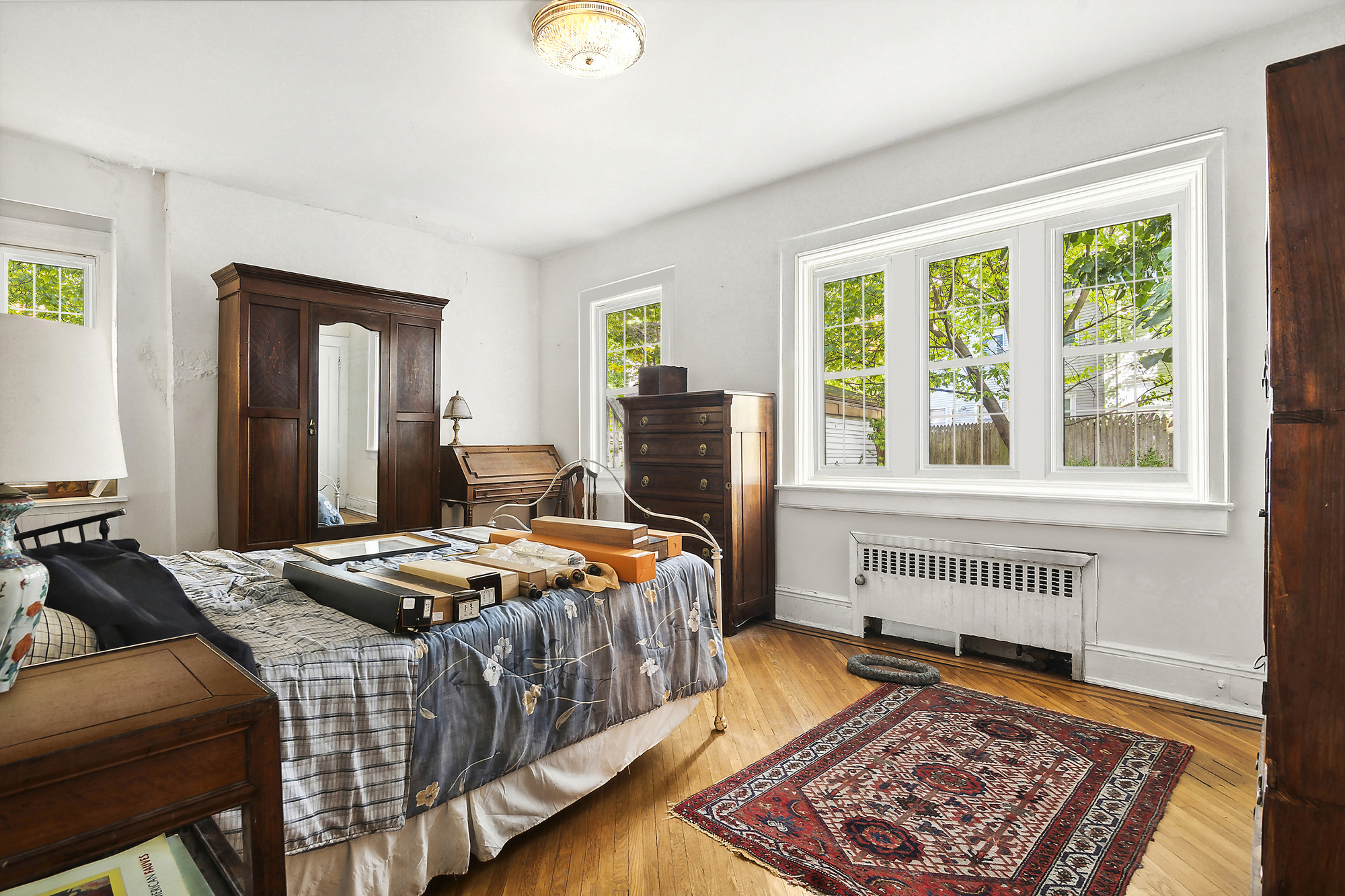 819 East 19th Street Brooklyn, NY 11230 - Photo 8 of 16 a bedroom with bed and wooden floor