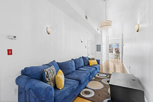 a living room with furniture and wooden floor