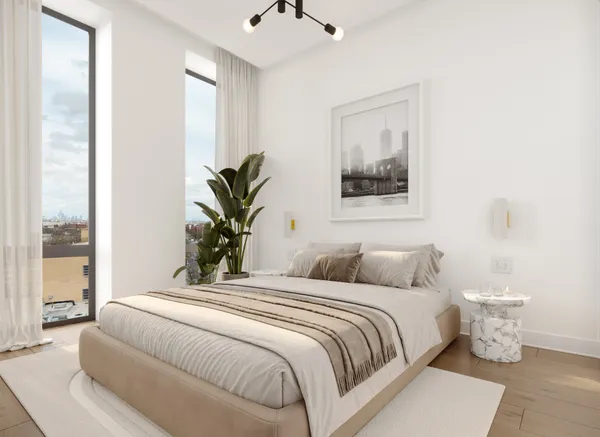 a bedroom with a large bed and a potted plant