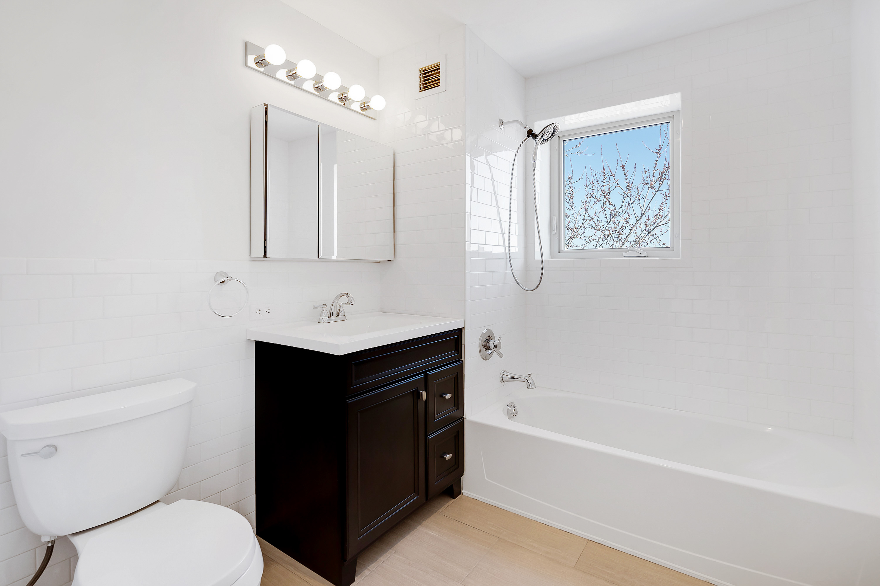 26-20 14th Place, Unit 3D Queens, NY 11102 - Photo 6 of 12 a bathroom with a toilet sink and mirror