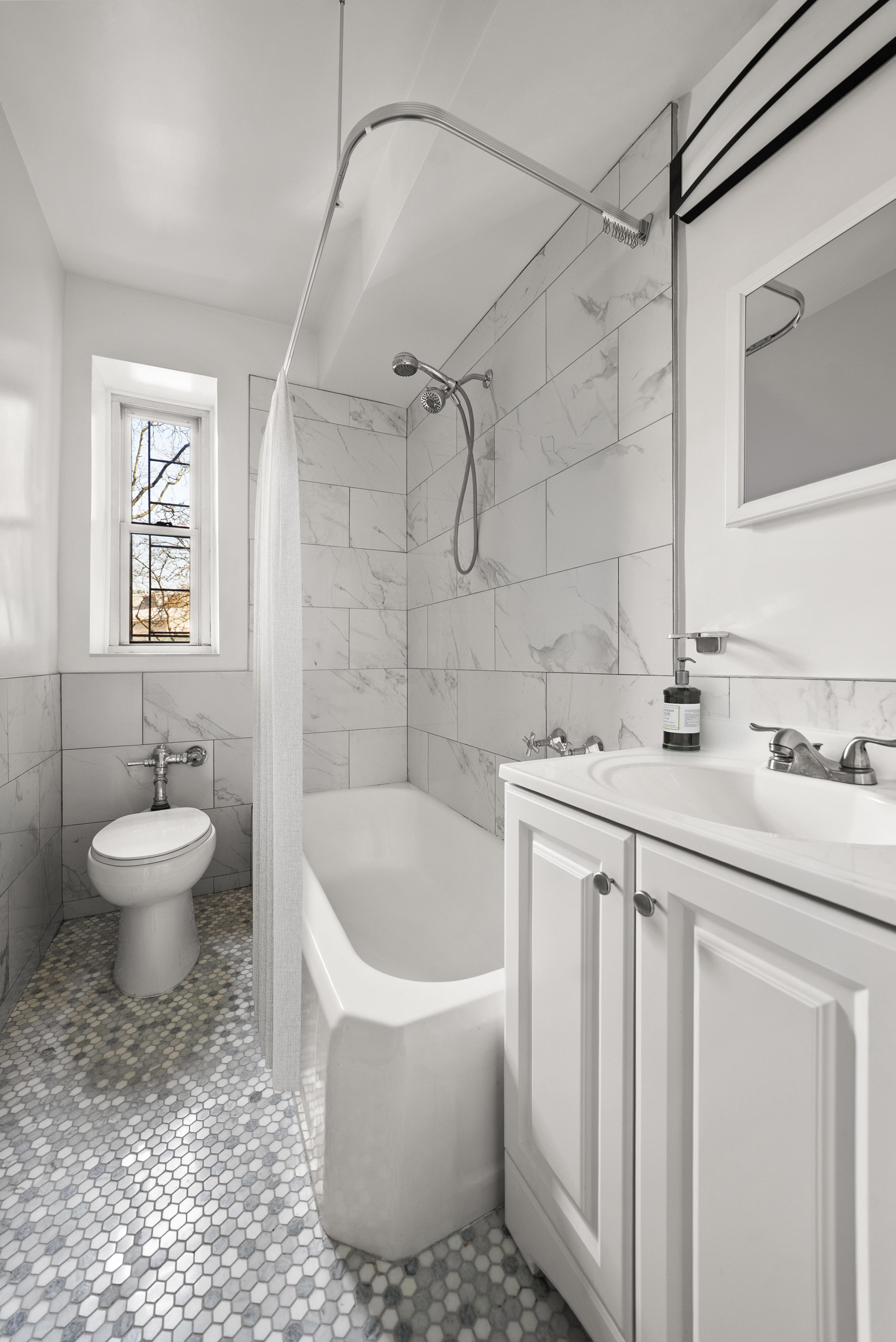 530 East 90th Street, Unit 2M Manhattan, NY 10128 - Photo 7 of 12 a bathroom with a sink a toilet and shower