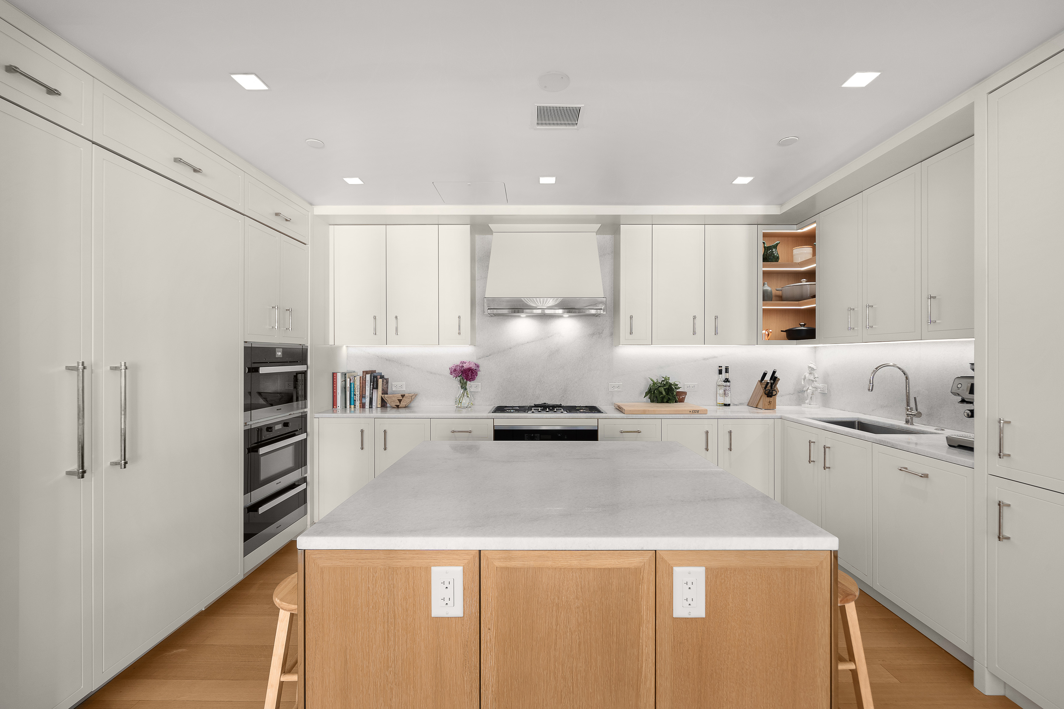 200 East 83rd Street, Unit 4E Manhattan, NY 10028 - Photo 6 of 29 a large white kitchen with stainless steel appliances