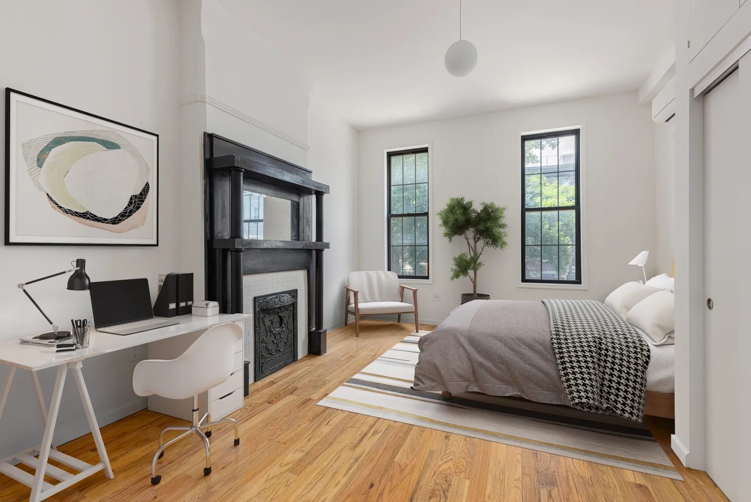 a bedroom with a bed wooden floor and a fireplace