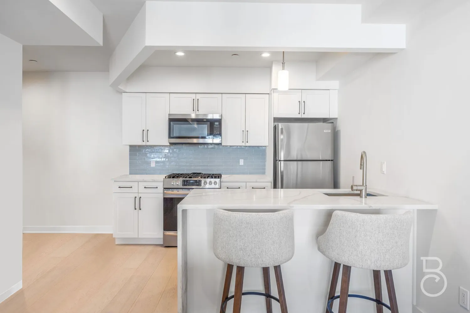 a kitchen with kitchen island granite countertop a sink cabinets and refrigerator