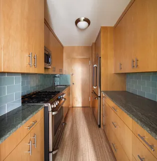 a kitchen with granite countertop a stove and a sink