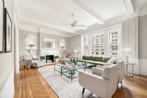 a living room with fireplace furniture and a large window