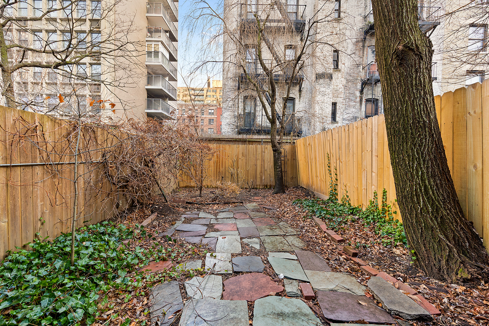 127 West 95th Street Manhattan, NY 10025 - Photo 13 of 15 a backyard of a house with lots of green space