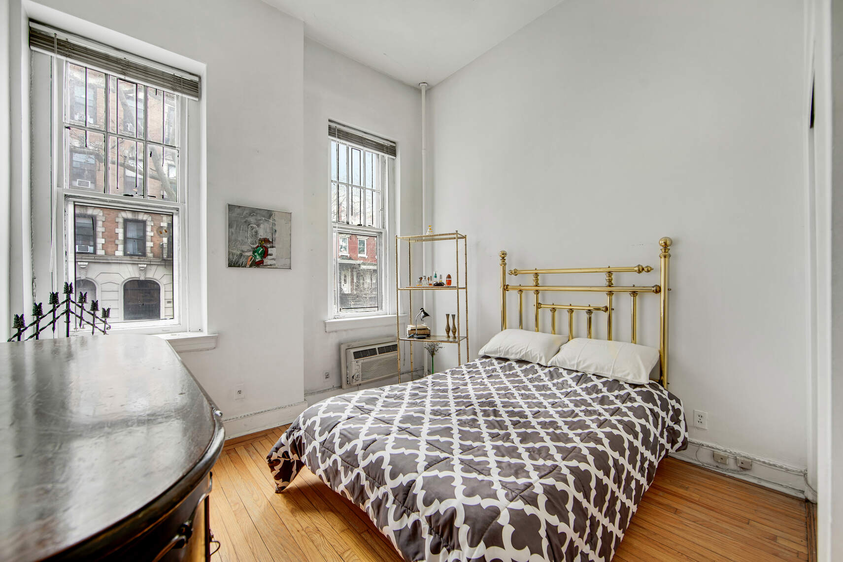 337 East 18th Street Manhattan, NY 10003 - Photo 3 of 16 a bedroom with a large bed and a table