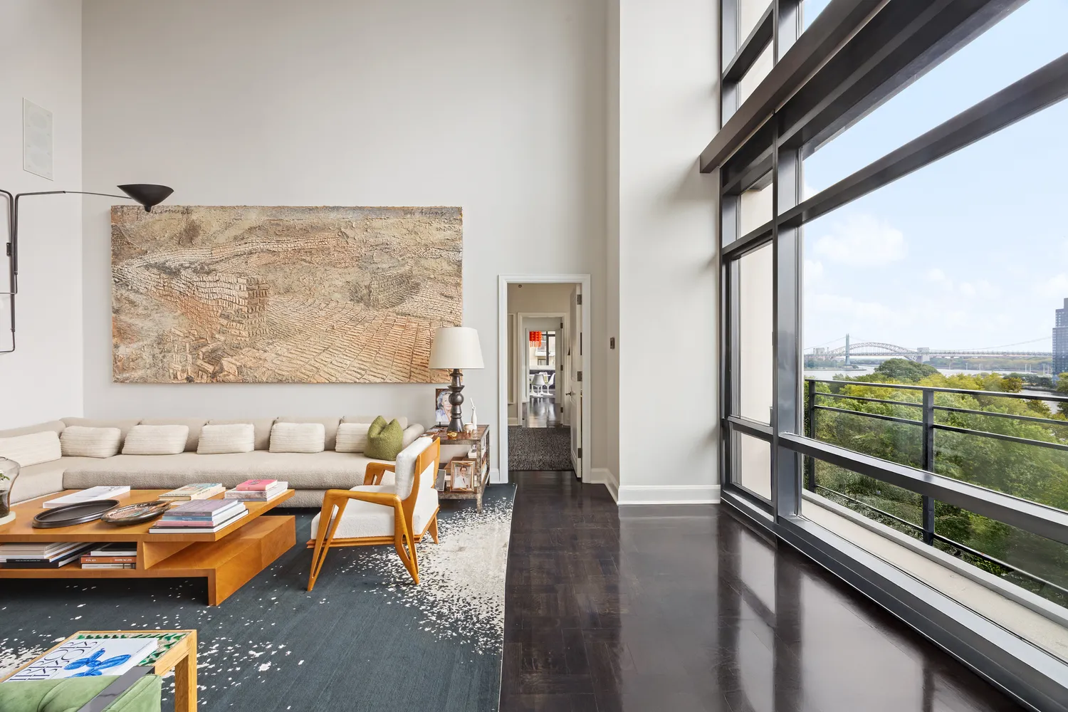 a living room with furniture and a floor to ceiling window