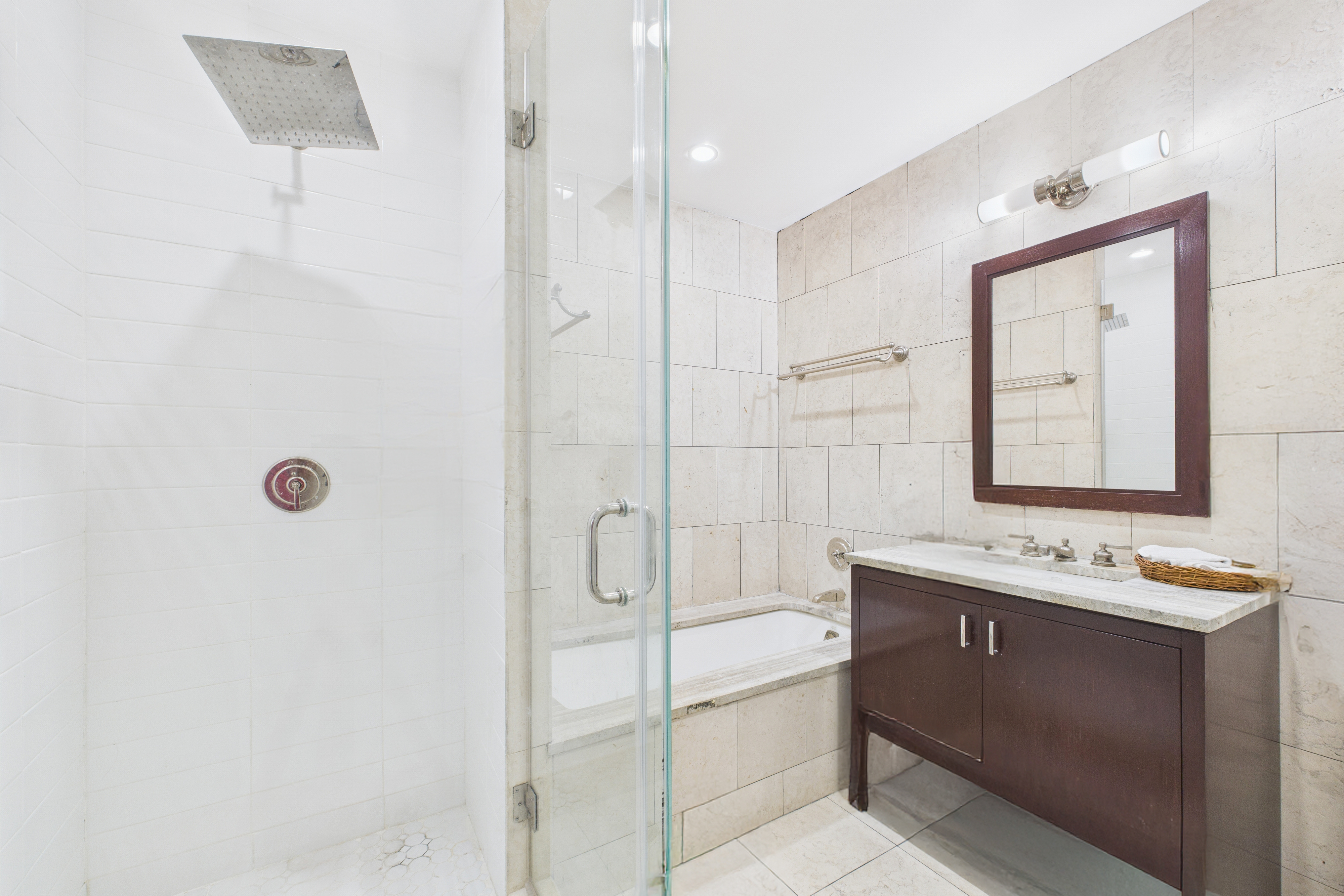 100 Riverside Boulevard, Unit 12B Manhattan, NY 10069 - Photo 9 of 10 a bathroom with a shower sink and mirror