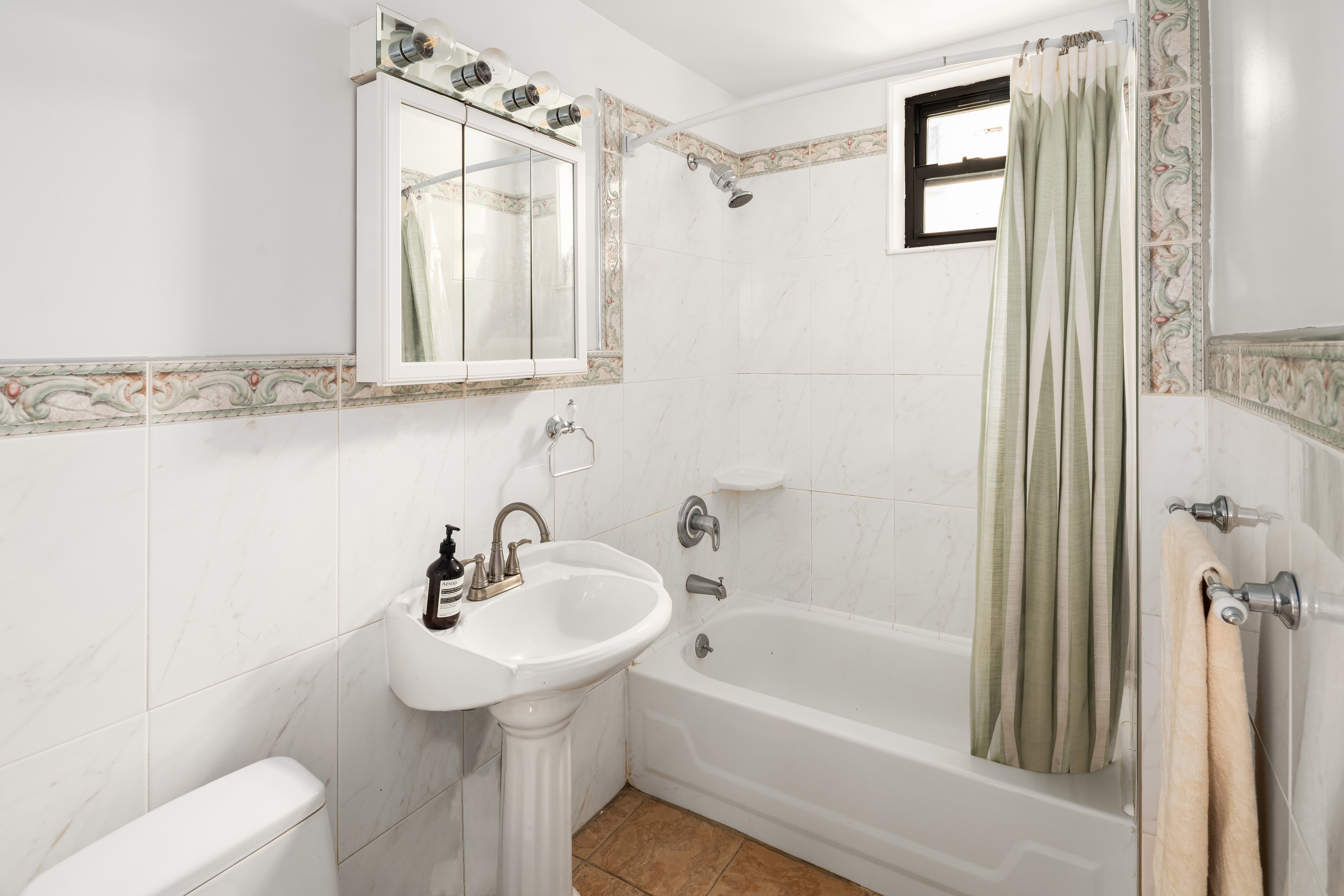 328 Sterling Place, Unit 1A Brooklyn, NY 11238 - Photo 5 of 7 a bathroom with a sink a toilet and shower