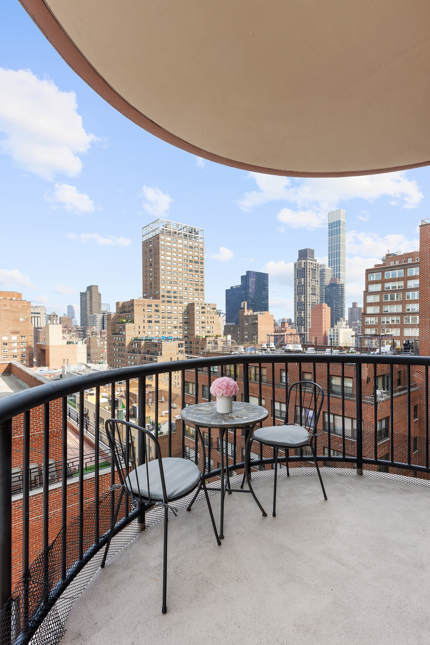 304 East 65th Street, Unit 14D Manhattan, NY 10065 - Photo 7 of 14 a view of a tall building from a balcony
