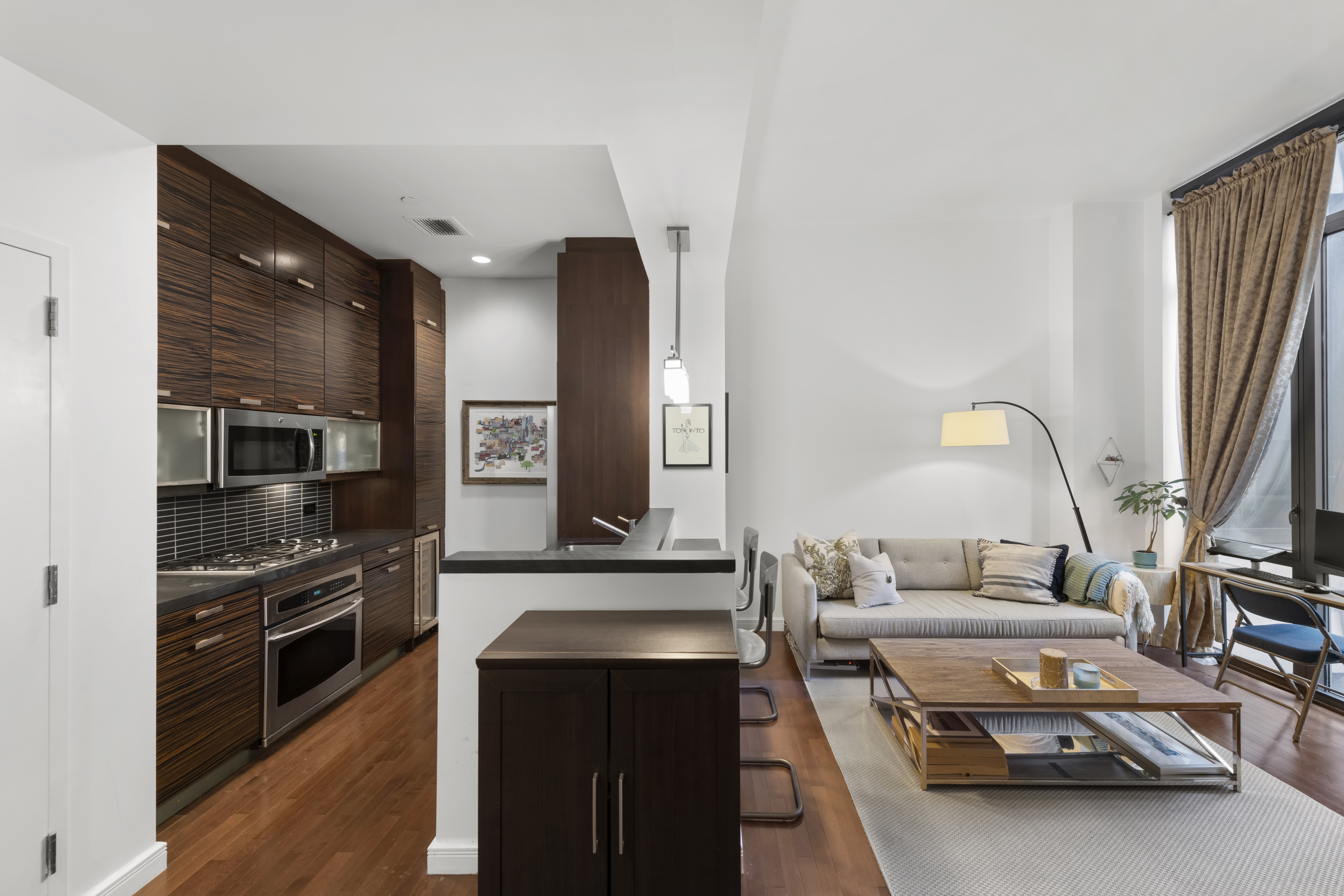 101 West 24th Street, Unit 5G Manhattan, NY 10011 - Photo 3 of 16 a kitchen with stainless steel appliances a sink and a stove